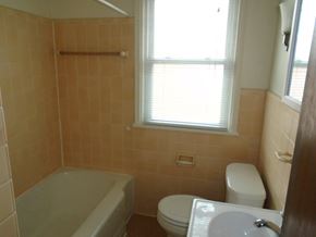 St Paul apartment for rent - a bathroom with a toilet and a tub and a window