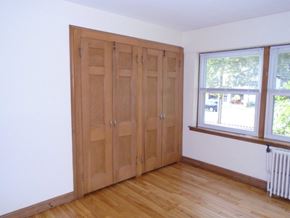 St Paul apartment for rent - an empty room with wooden floors and wooden doors