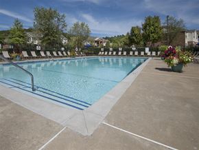 Fayetteville apartment for rent - a resort style pool with chairs around it