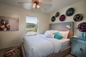 Fayetteville apartment for rent - a bedroom with a large bed and a ceiling fan