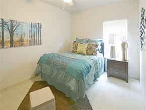 Fayetteville apartment for rent - a bedroom with a bed and a painting on the wall