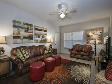 Fayetteville apartment for rent - a living room with leather furniture and a ceiling fan