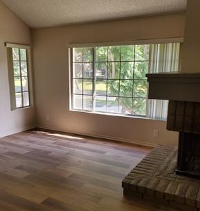 Irvine apartment for rent - an empty living room with a fireplace and a large window