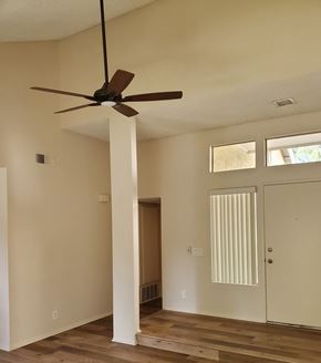 Irvine apartment for rent - an empty room with a ceiling fan and a door