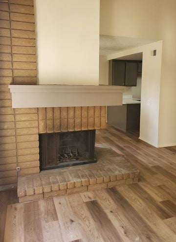 Irvine apartment for rent - a living room with a fireplace and a wooden floor