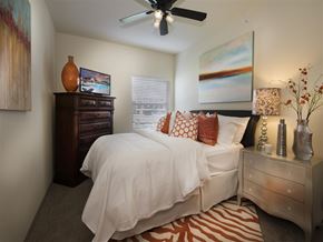 Fayetteville apartment for rent - a bedroom with a bed and a ceiling fan