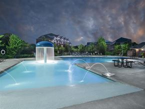 Fayetteville apartment for rent - a swimming pool with a water fountain at night