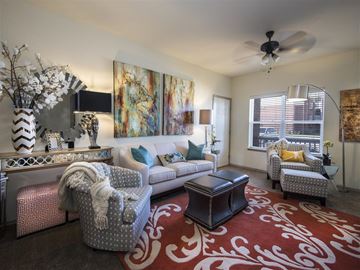 Fayetteville apartment for rent - a living room with furniture and a ceiling fan