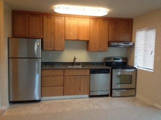 San Francisco apartment for rent - a kitchen with stainless steel appliances and wooden cabinets