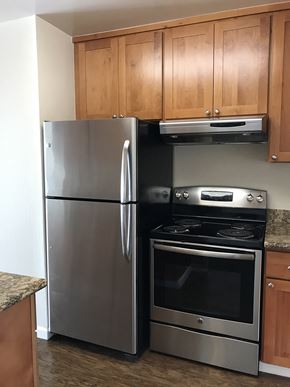 San Francisco apartment for rent - a kitchen with stainless steel appliances and wooden cabinets