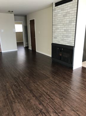 San Francisco apartment for rent - an empty living room with wood floors and a fireplace