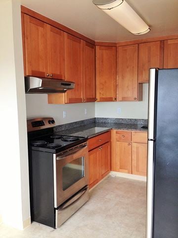 San Francisco apartment for rent - a kitchen with stainless steel appliances and wooden cabinets