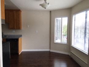 San Francisco apartment for rent - an empty room with a kitchen and a large window