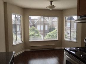 San Francisco apartment for rent - an empty kitchen with a stove and a large window