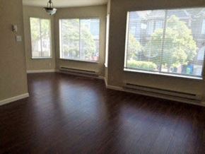 San Francisco apartment for rent - an empty living room with wood floors and large windows