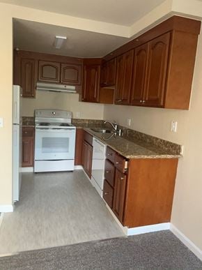 San Francisco apartment for rent - an empty kitchen with white appliances and granite counter tops