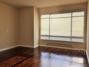San Francisco apartment for rent - an empty living room with a large window and wooden floors