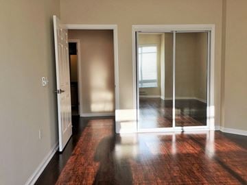 San Francisco apartment for rent - an empty living room with wood floors and sliding glass doors
