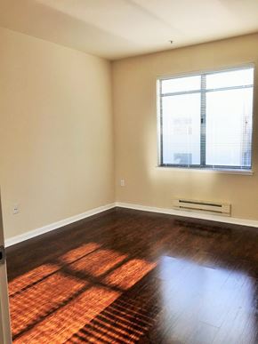 San Francisco apartment for rent - an empty living room with wood floors and a window