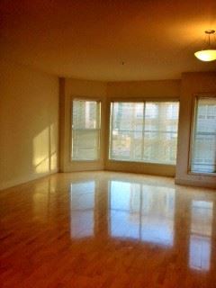 San Francisco apartment for rent - an empty living room with a hard wood floor and windows