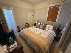 Seattle apartment for rent - a bedroom with a bed and a dresser and a window