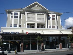 Seattle apartment for rent - a large white building on the corner of a street