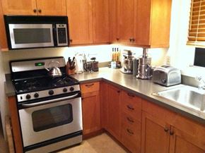 Seattle apartment for rent - a kitchen with a stove microwave and sink