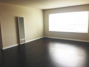 San Francisco apartment for rent - an empty living room with wood floors and a window
