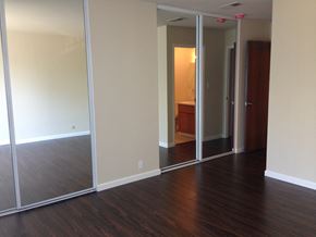 San Francisco apartment for rent - an empty living room with wood floors and mirrors