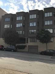 San Francisco apartment for rent - a large building with cars parked in front of it
