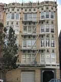 San Francisco apartment for rent - a tall building with many windows and a tree in front of it