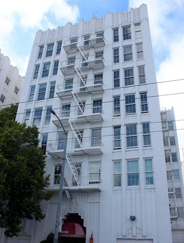 San Francisco apartment for rent - a tall white building with a fire escape