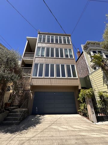 San Francisco apartment for rent - A tall building with a garage door in front.