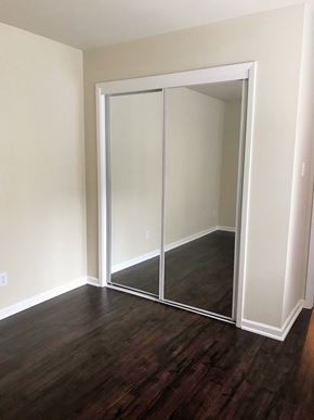 San Francisco apartment for rent - a room with a wood floor and a closet with mirrored doors