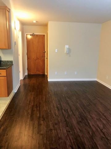 San Francisco apartment for rent - a living room with wood flooring and a door into a kitchen