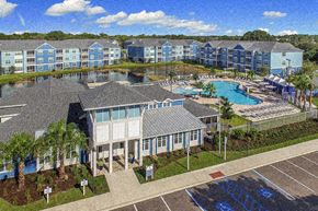 Bradenton apartment for rent - an aerial view of a resort with a pool and buildings