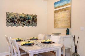 Bradenton apartment for rent - a dining room with a table and chairs and a painting on the wall
