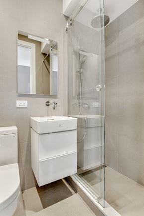 Brooklyn apartment for rent - a white bathroom with a shower sink and toilet
