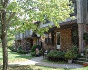 Meriden apartment for rent - a brick house with a tree in front of it