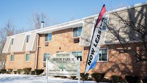 Meriden apartment for rent - a building with a sign and a flag in the snow