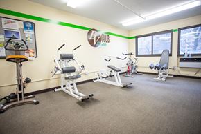 New Haven apartment for rent - a gym with various exercise machines and weights