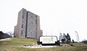 New Haven apartment for rent - a tall building on a hill next to a sign