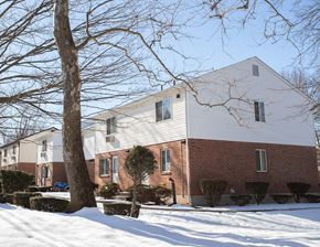 Meriden apartment for rent - a white house with a tree in the snow
