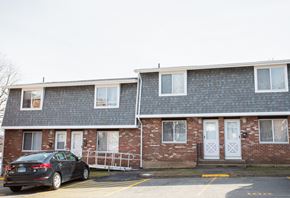Meriden apartment for rent - a car parked in front of a brick apartment building