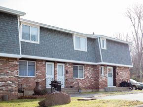 Meriden apartment for rent - a brick house with a blue roof and white windows