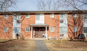 Meriden apartment for rent - the front of a brick building with a sidewalk in front of it