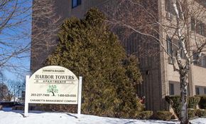 Meriden apartment for rent - a sign in front of a building with snow
