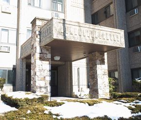 Meriden apartment for rent - the front entrance of a building with snow on the ground