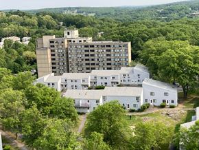 Worcester apartment for rent - A large white building with a smaller brown building behind it.