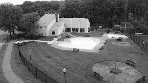 Worcester apartment for rent - A black and white image of a park with a playground and a building in the background.